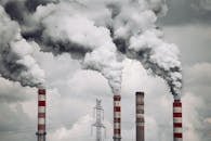 pexels photo 19419368 19419368 Smoke billows from factory chimneys in Konin, Poland, highlighting pollution and environmental impact.