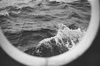 pexels photo 9319512 9319512 Artistic view of ocean waves through a ship's porthole in monochrome.