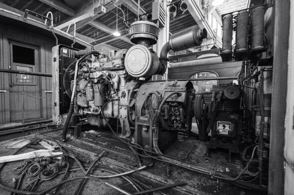 pexels photo 38303960 38303960 Black and white image of a vintage industrial engine inside a building.