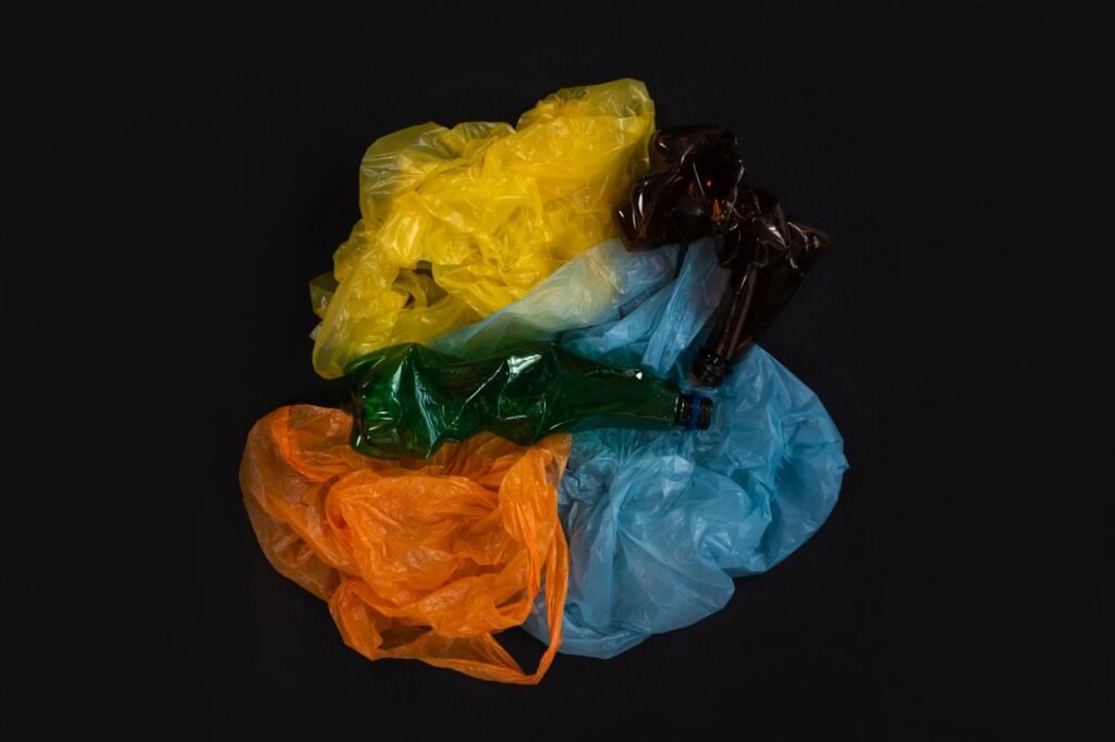 Vivid composition of plastic bags and bottles emphasizing recycling and environmental awareness.