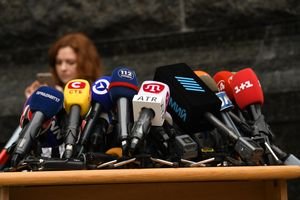 The Summer of 2026: Climate Reporting Without Accountability Various microphones setup at a press conference in Kyiv, Ukraine.